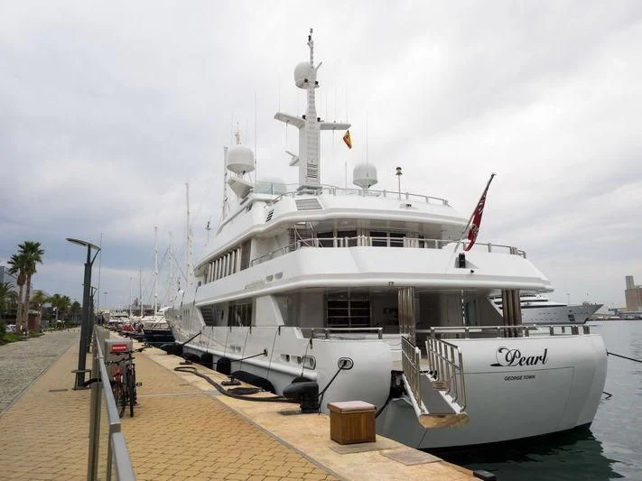 a large white ship docked aboard PEARL Yacht for Sale