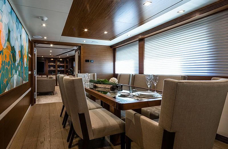 a room with a table chairs and a window aboard NORTHLAND Yacht for Sale
