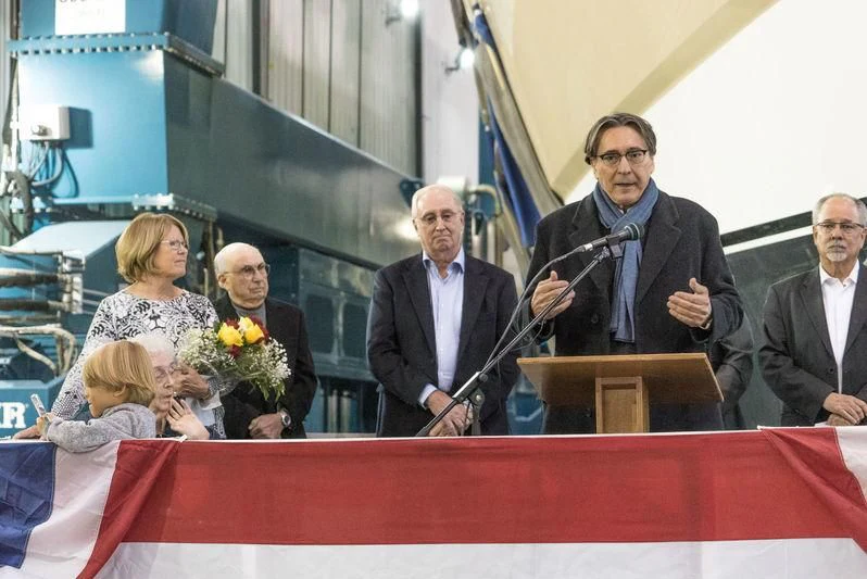a man and woman standing at a podium with a microphone aboard NORTHLAND Yacht for Sale