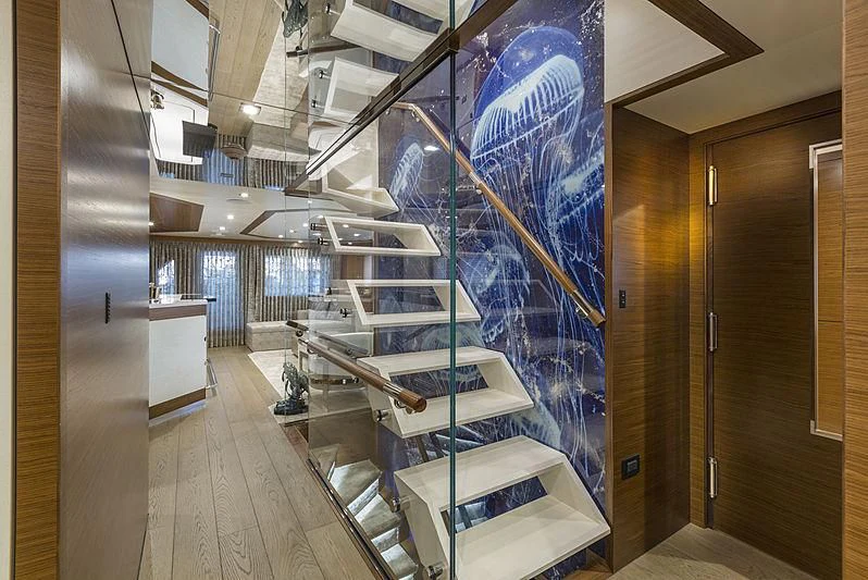 a room with glass walls and a staircase aboard NORTHLAND Yacht for Sale