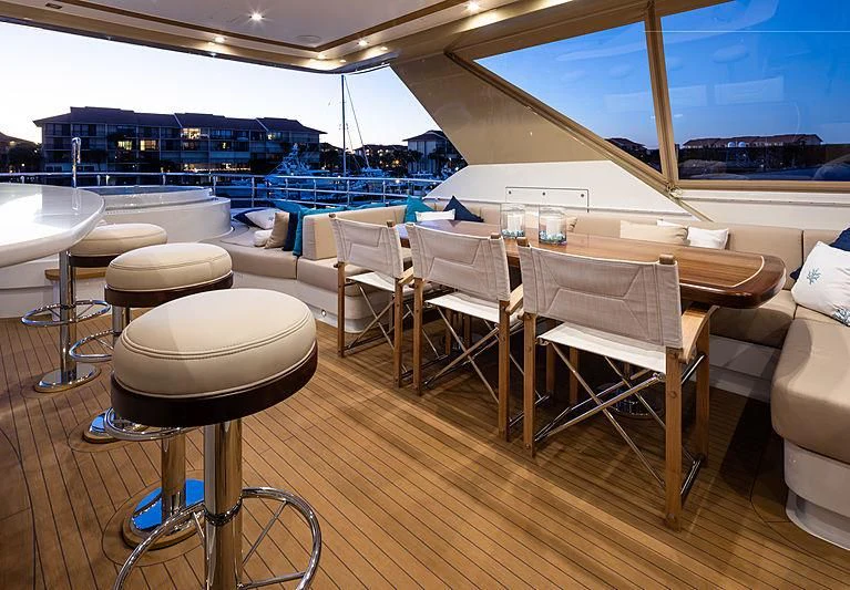 a room with tables and chairs aboard NORTHLAND Yacht for Sale