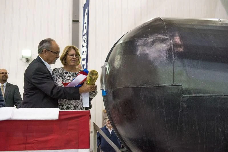a man and a woman standing next to a black object aboard NORTHLAND Yacht for Sale