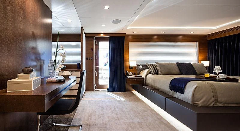 a room with a bed and desk aboard NORTHLAND Yacht for Sale