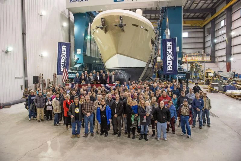 a group of people posing for a photo in front of a large rocket aboard NORTHLAND Yacht for Sale