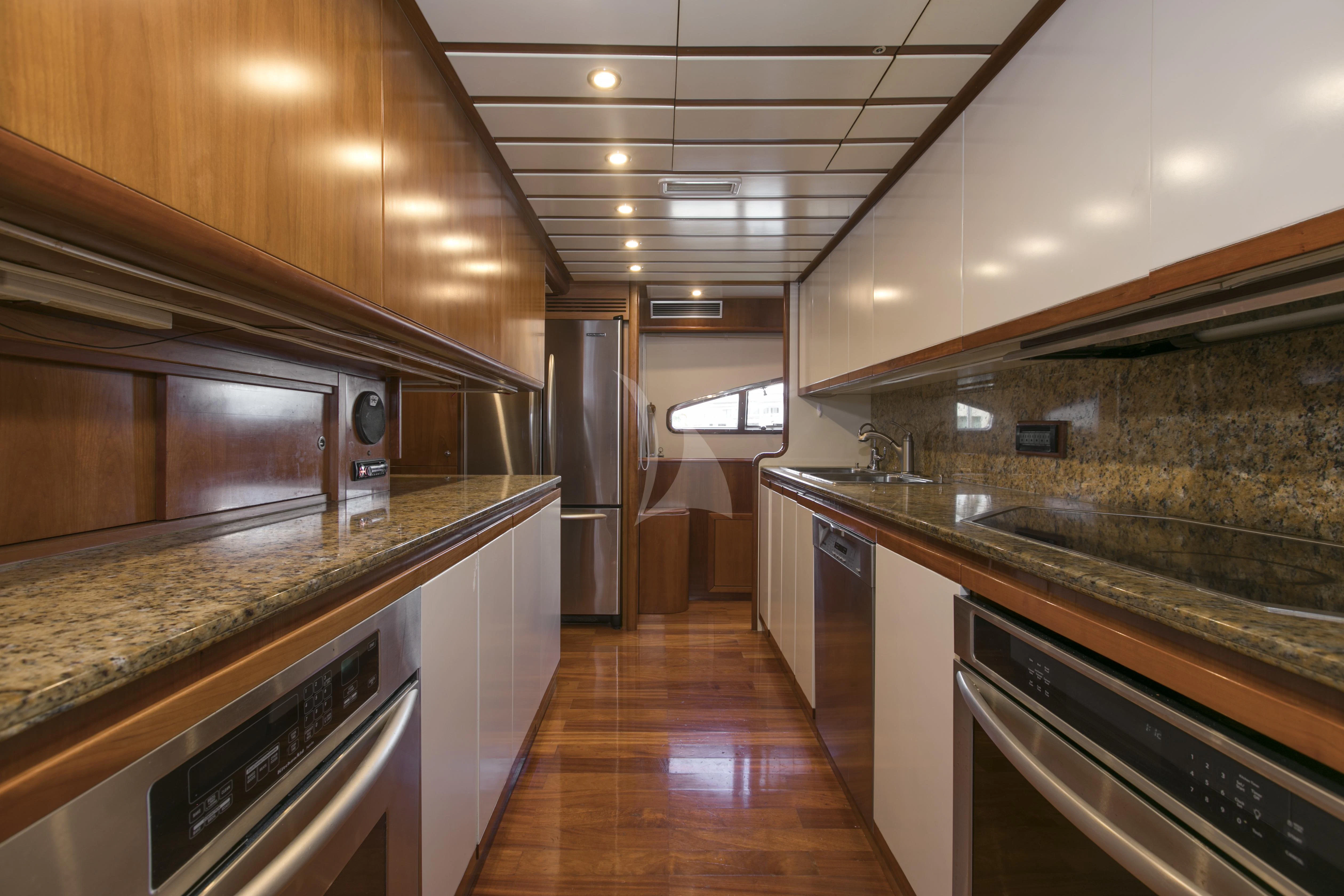 a kitchen with stainless steel appliances aboard MAMBO Yacht for Sale