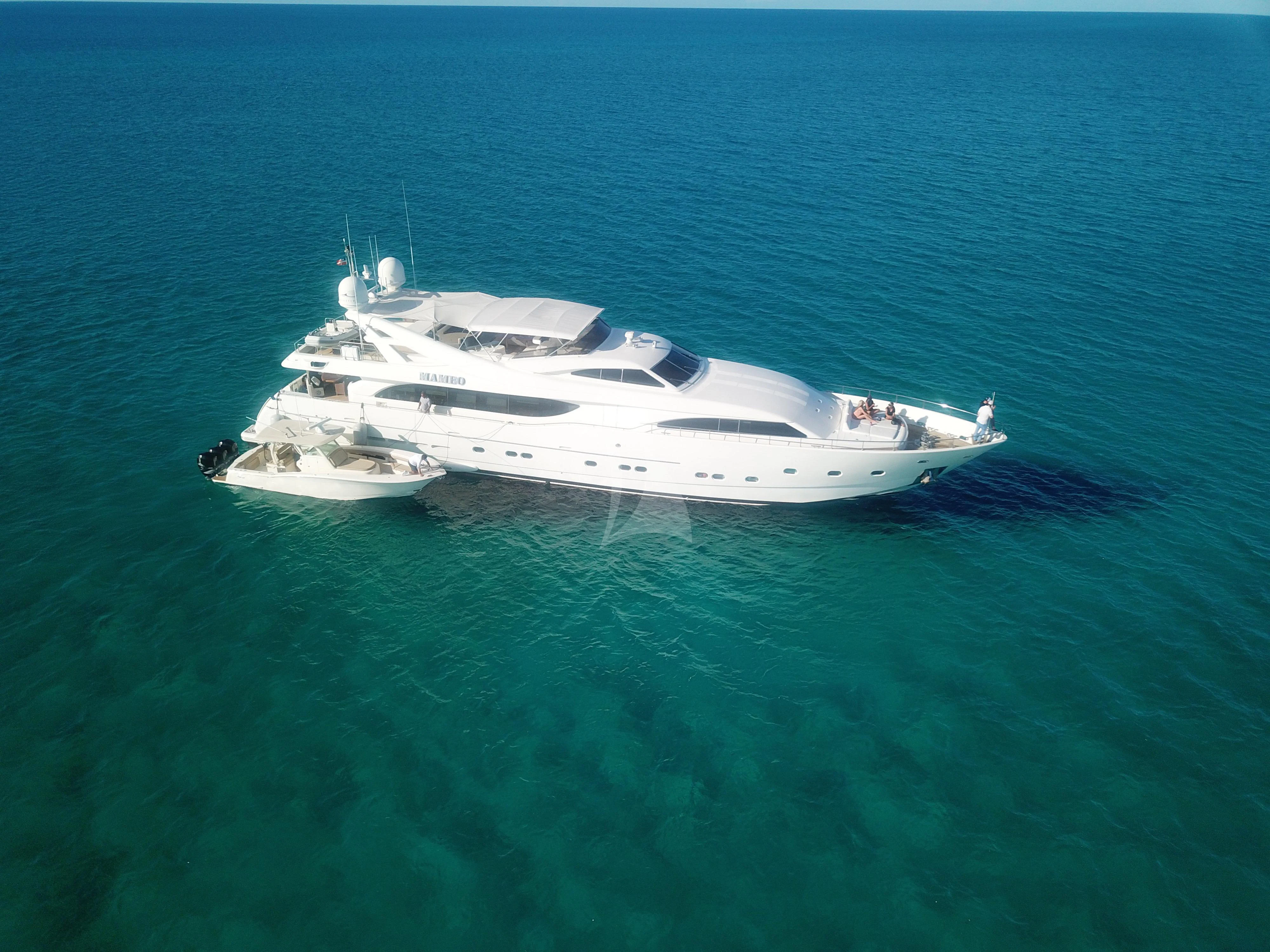 a white yacht in the ocean aboard MAMBO Yacht for Sale