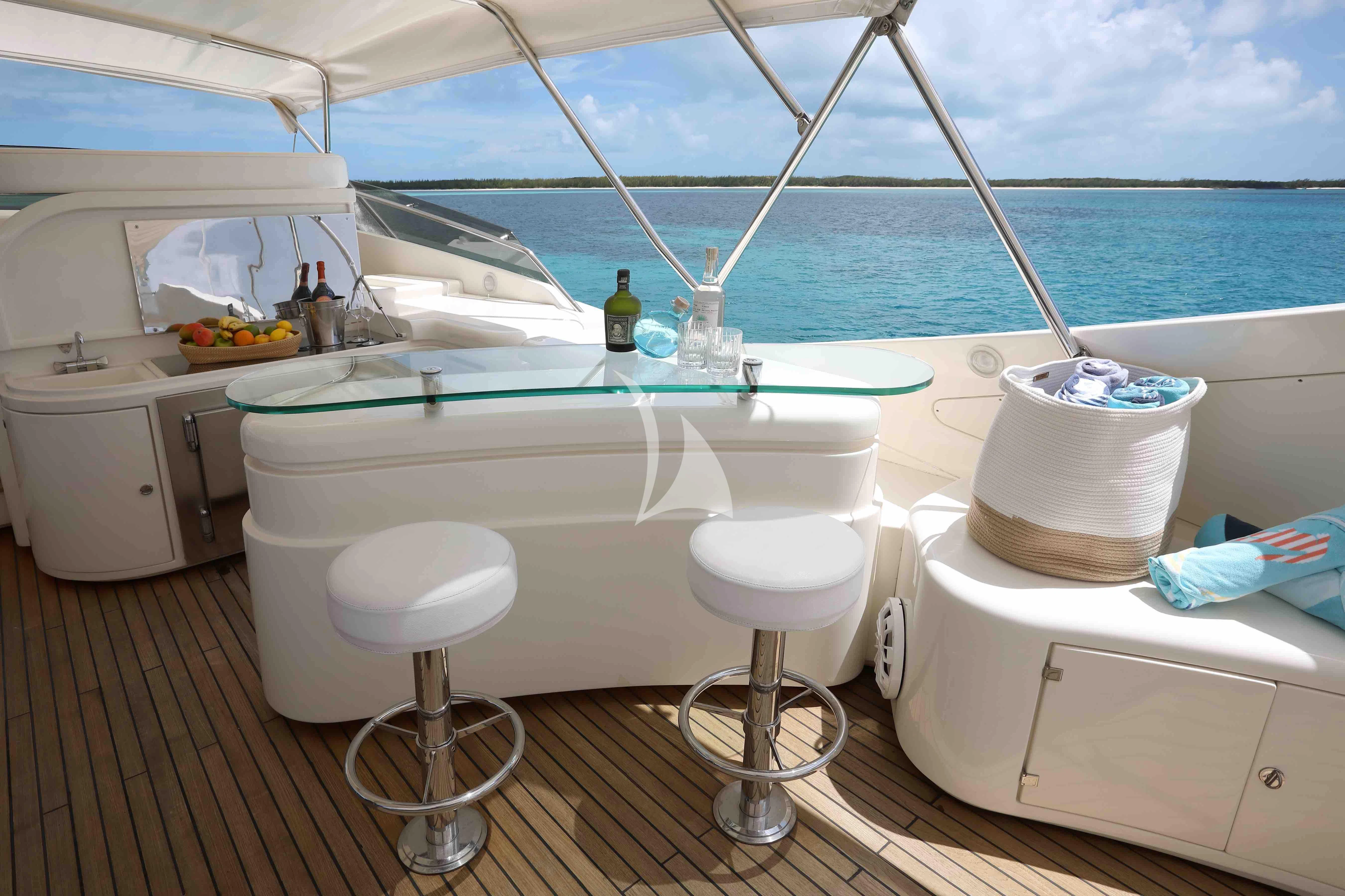 a boat with a sink and stools on the side aboard MAMBO Yacht for Sale