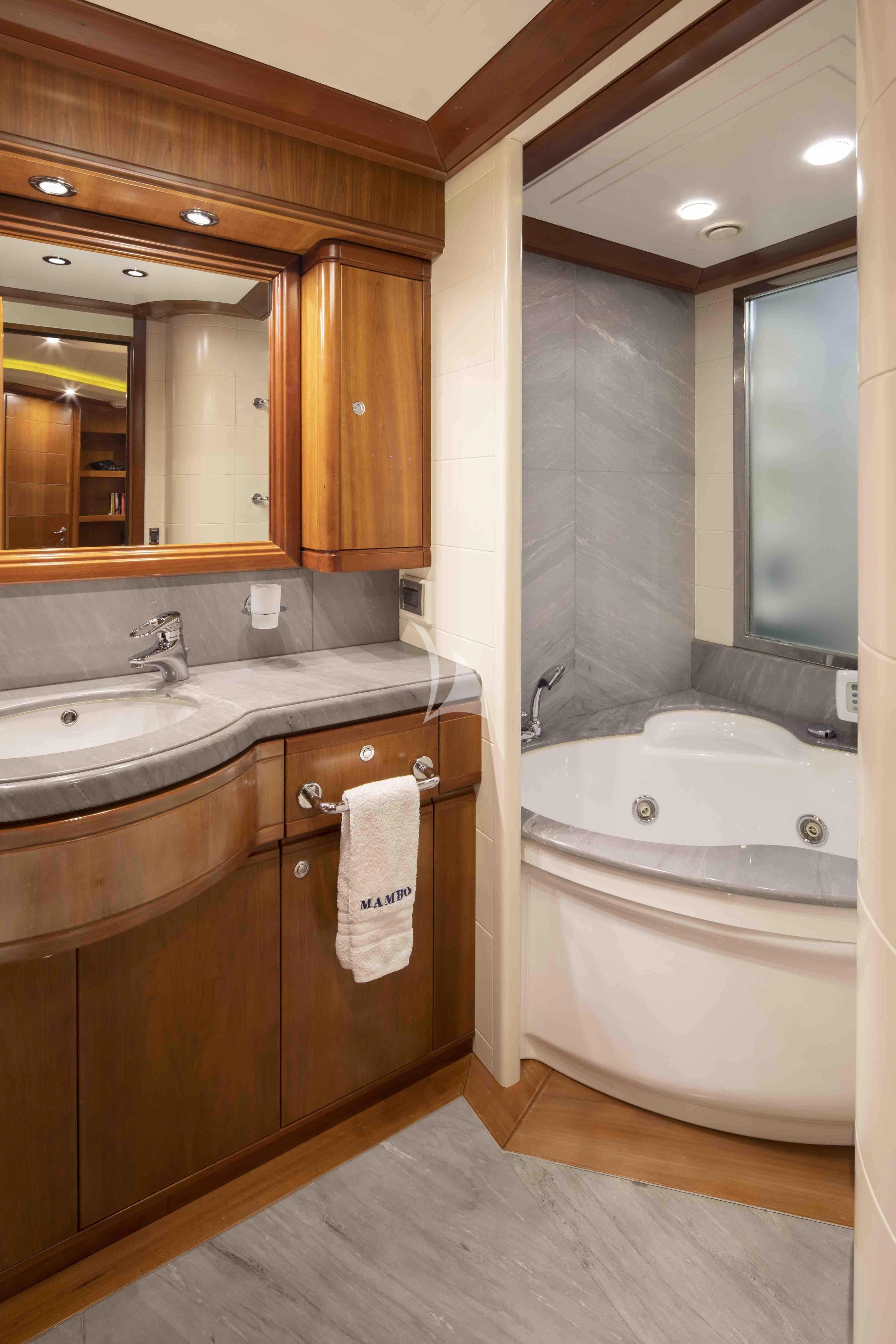 a bathroom with a large mirror aboard MAMBO Yacht for Sale