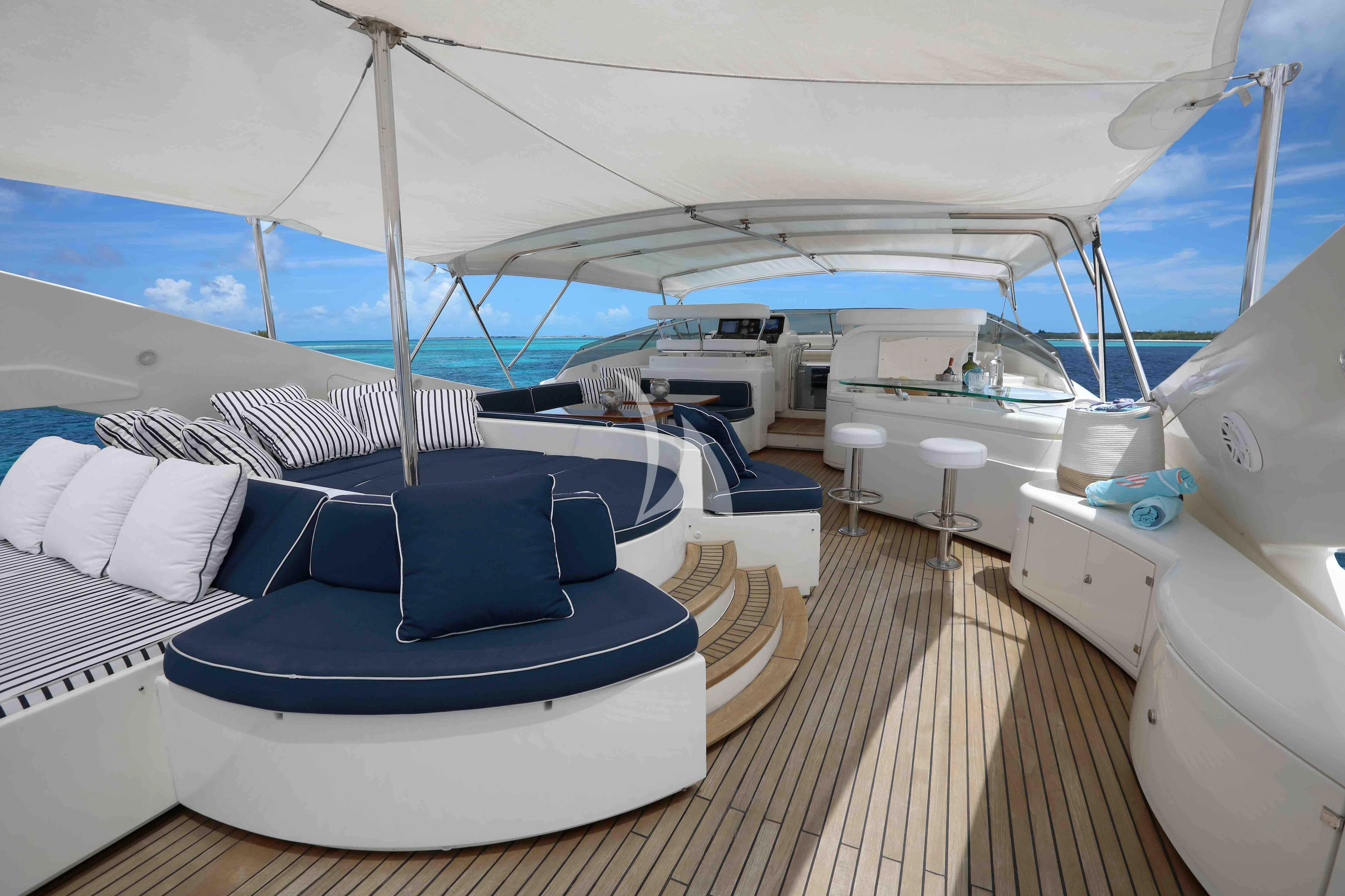 a boat with a deck and chairs aboard MAMBO Yacht for Sale