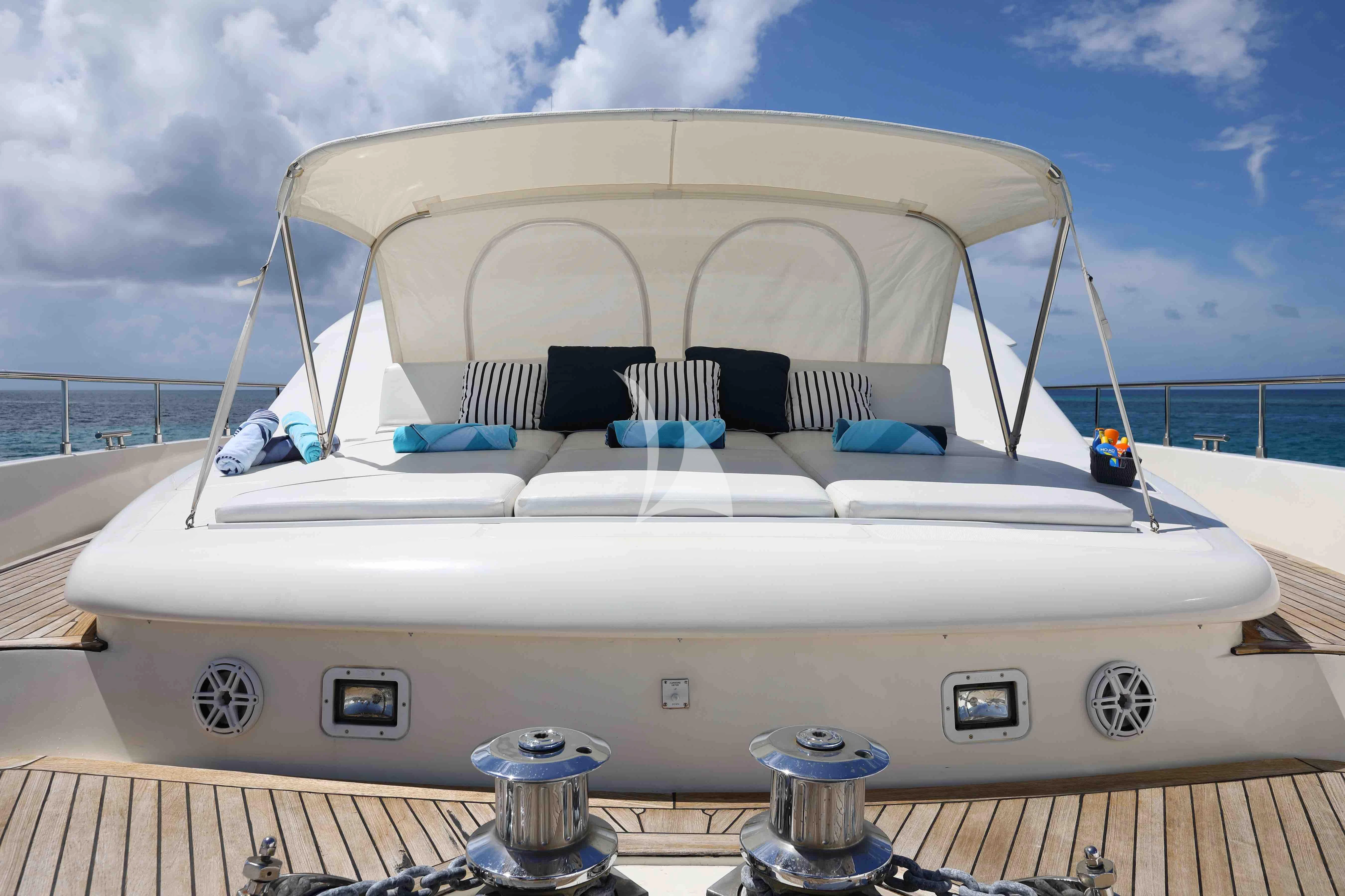 a white boat on a deck aboard MAMBO Yacht for Sale
