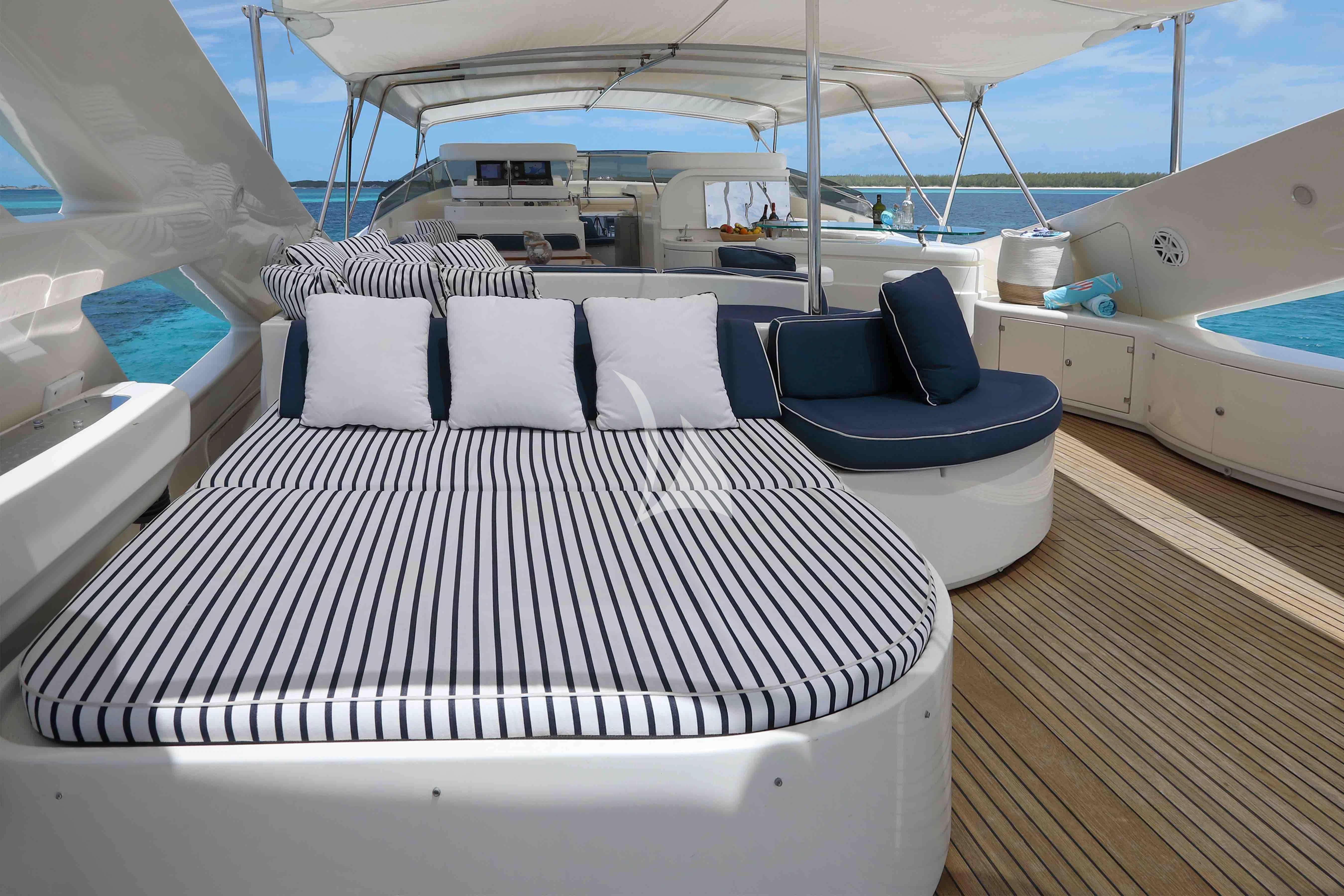 a boat with a bed and a chair on the deck aboard MAMBO Yacht for Sale