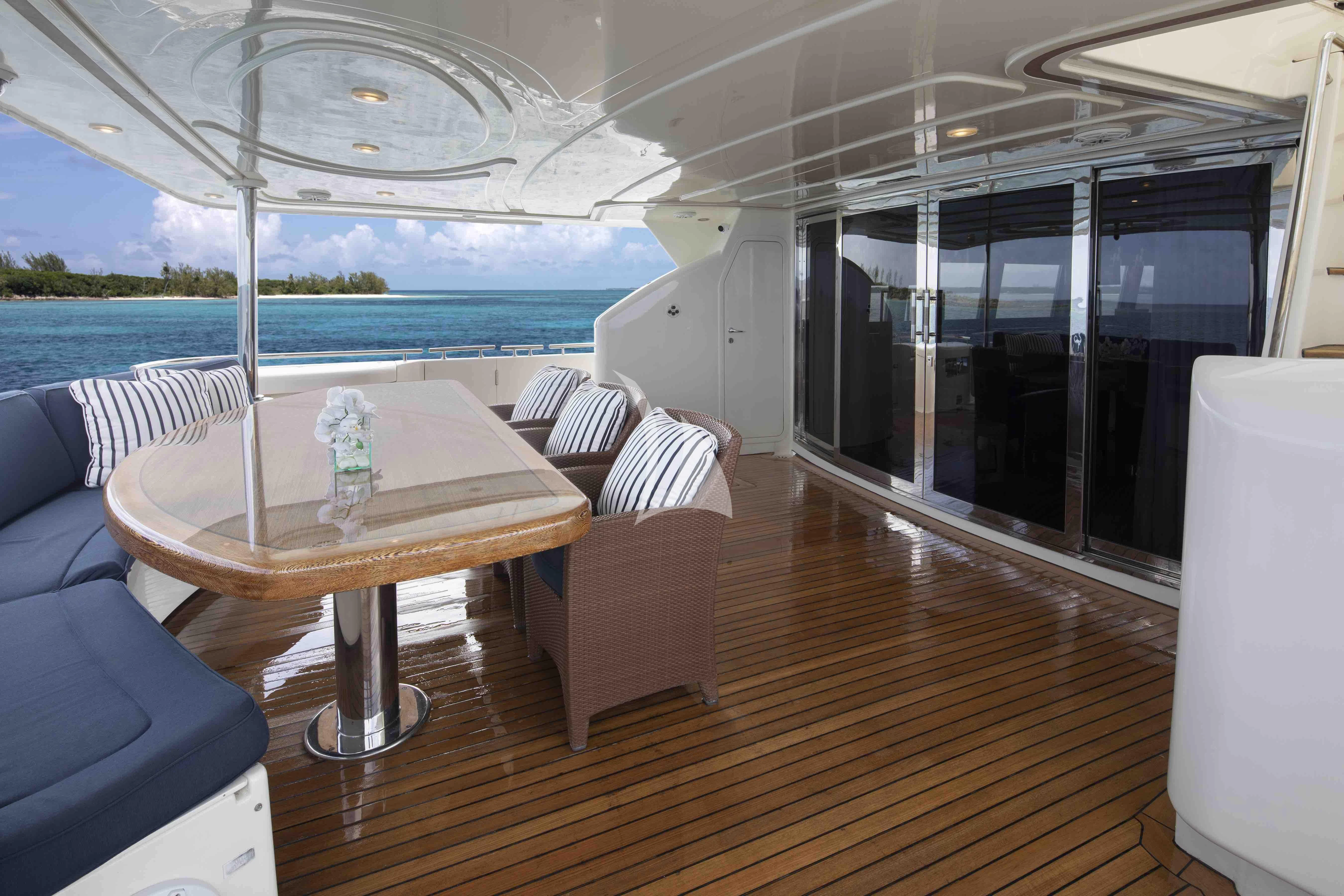 a table and chairs on a deck aboard MAMBO Yacht for Sale