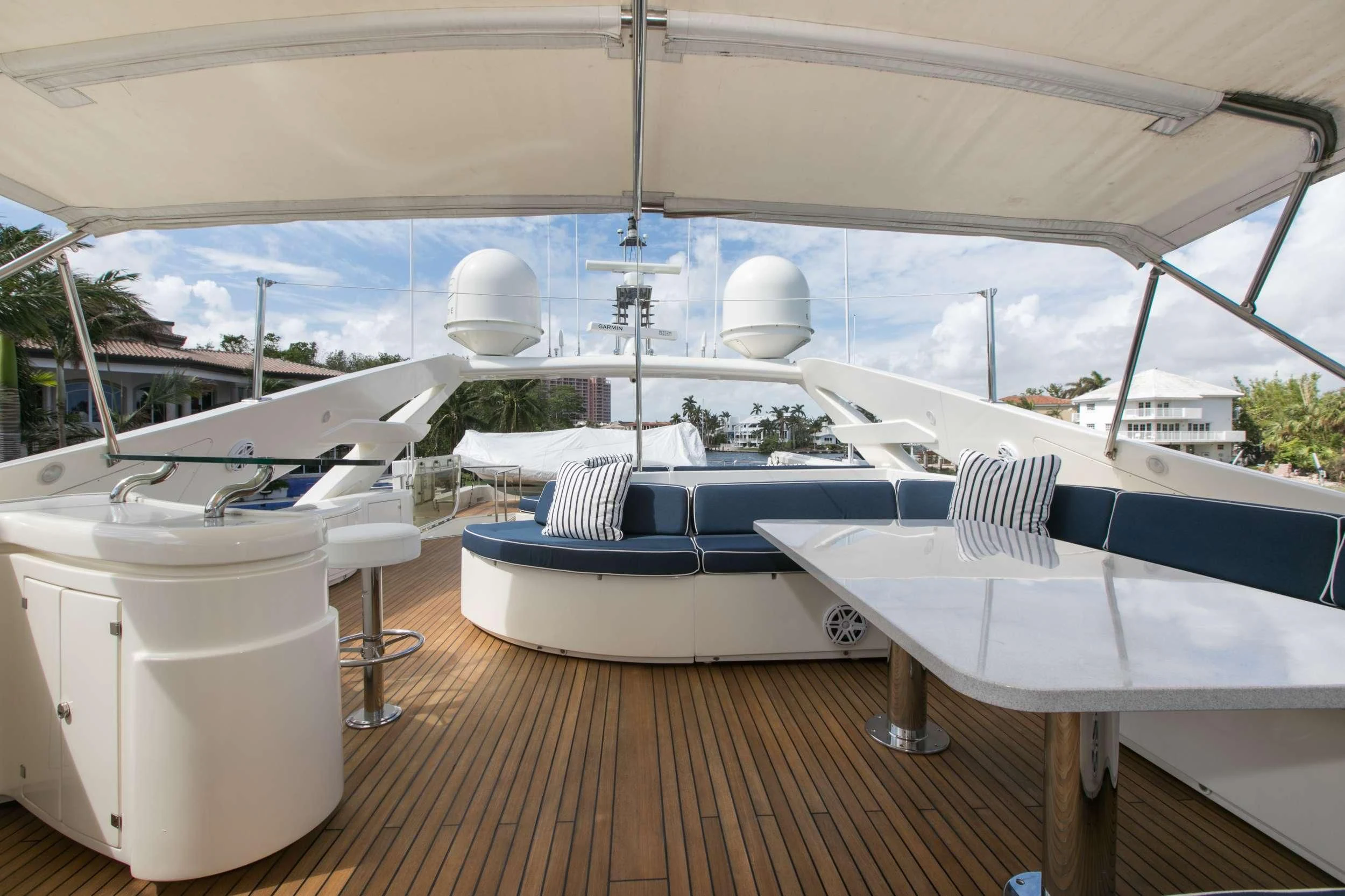 a large white tent with white tables and chairs aboard MAMBO Yacht for Sale