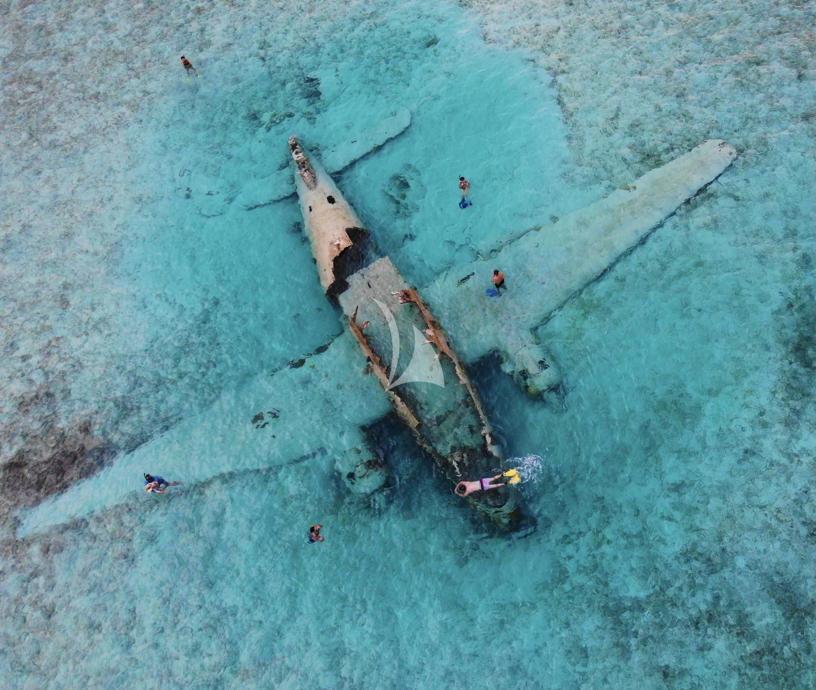 a large military tank on a beach aboard MAMBO Yacht for Sale
