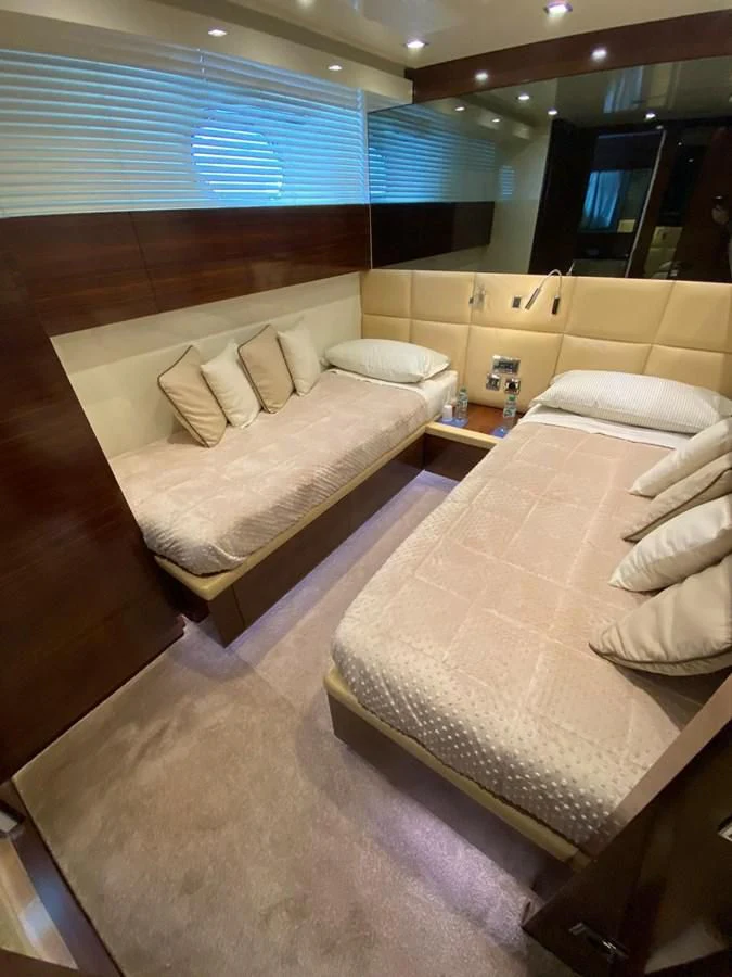 a room with a bed and a mirror aboard ELAN Yacht for Sale