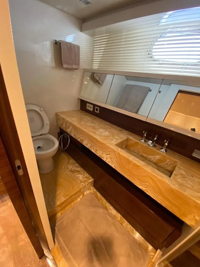 a bathroom with a countertop sink and a toilet aboard ELAN Yacht for Sale