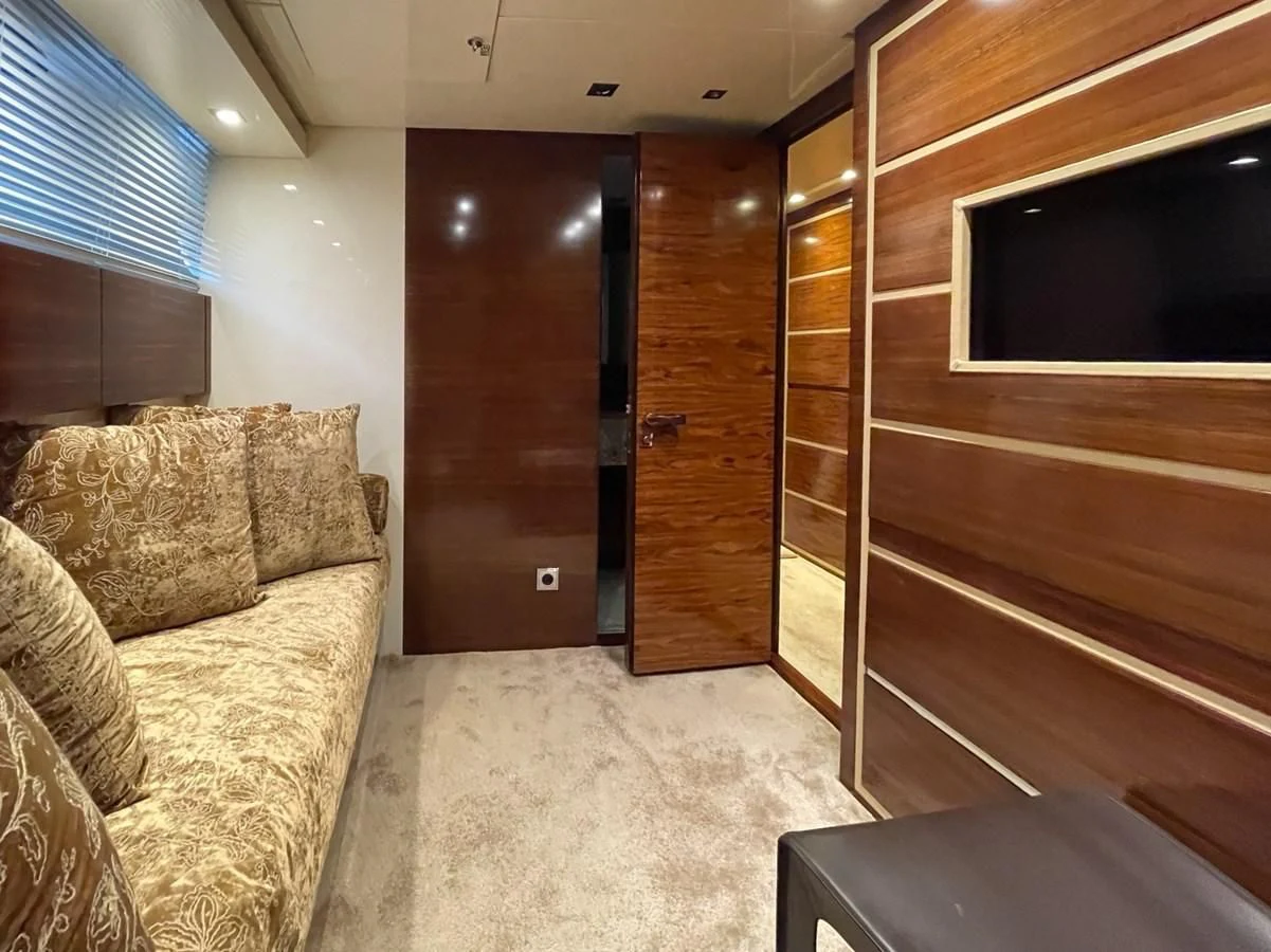 a living room with a couch and a tv aboard ELAN Yacht for Sale
