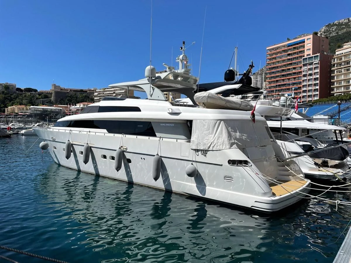 a white yacht in a harbor aboard ELAN Yacht for Sale