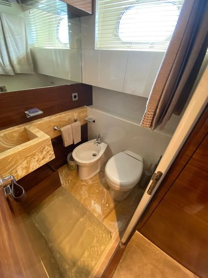 a bathroom with a toilet and sink aboard ELAN Yacht for Sale