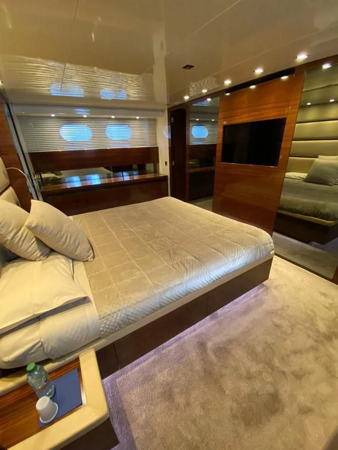 a room with a bed and a window aboard ELAN Yacht for Sale