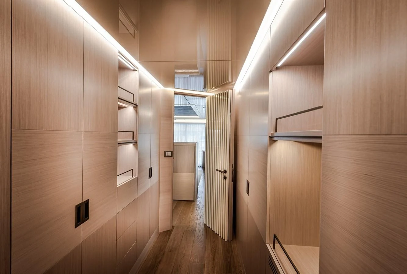 a room with wooden floors and white walls aboard PROJECT 105 Yacht for Sale