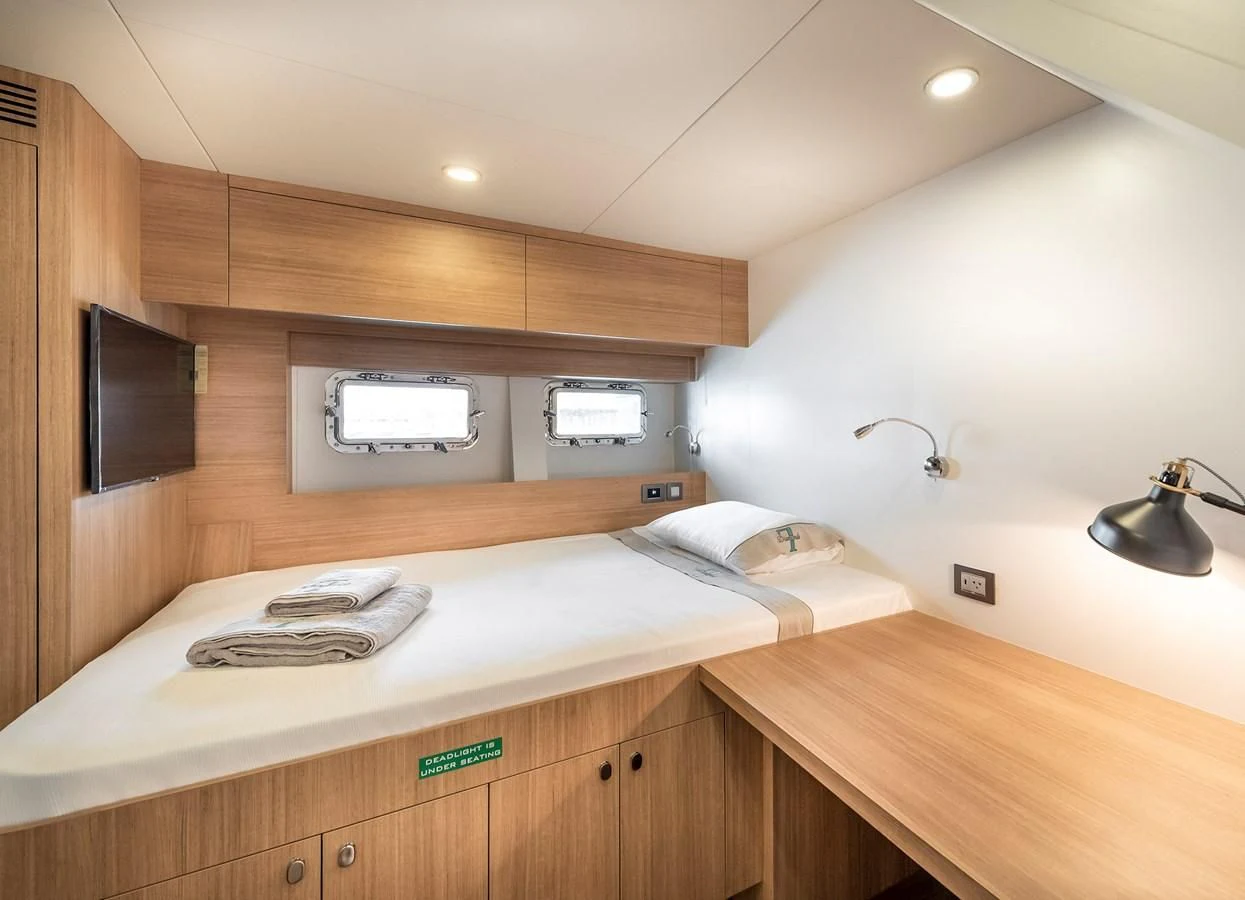 a bedroom with a bed and a television aboard PROJECT 105 Yacht for Sale