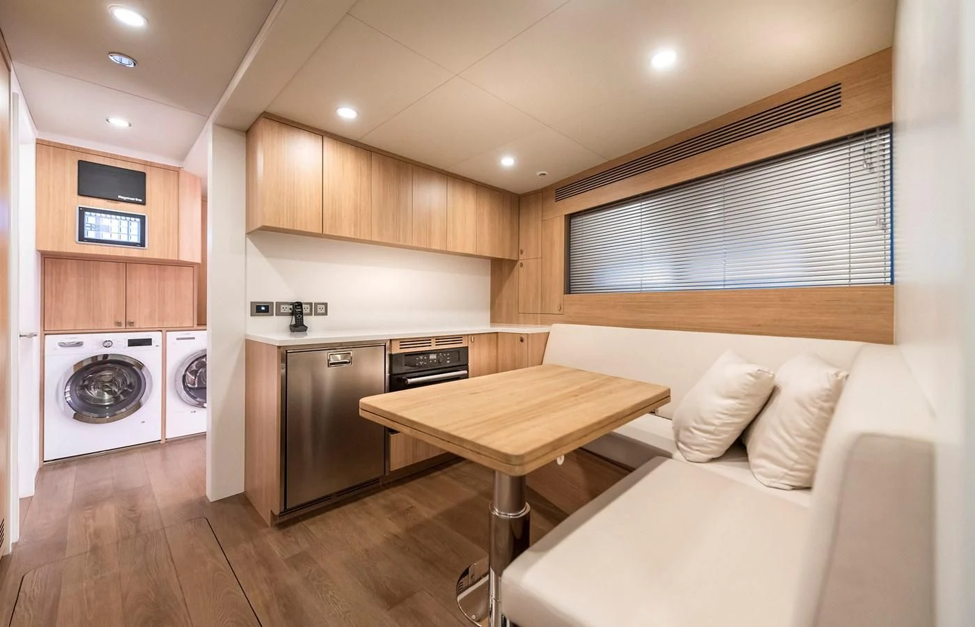 a kitchen with a table and a couch aboard PROJECT 105 Yacht for Sale