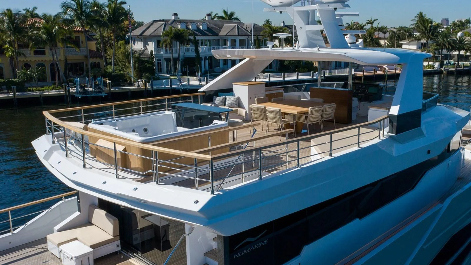 a large pool with lounge chairs and tables on the deck aboard PROJECT 105 Yacht for Sale