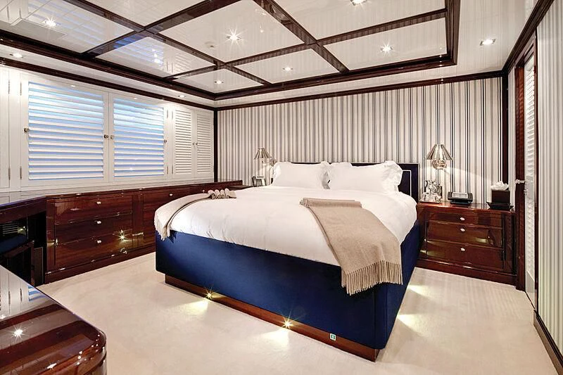 a bedroom with a bed and a desk aboard OXYGEN Yacht for Sale