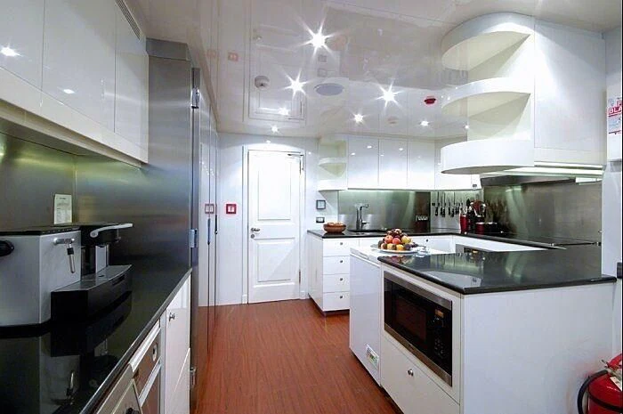 a kitchen with white cabinets aboard OXYGEN Yacht for Sale
