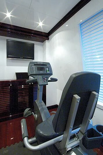 a room with a tv and a chair aboard OXYGEN Yacht for Sale