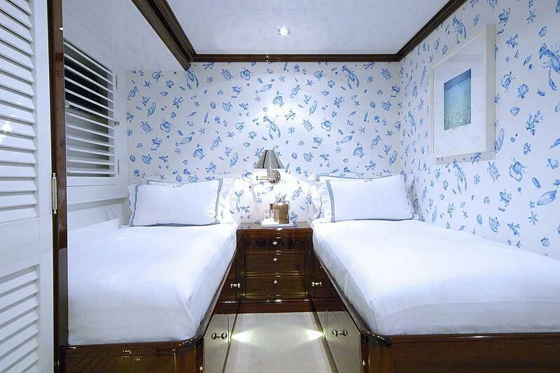 a room with a couple of beds aboard OXYGEN Yacht for Sale