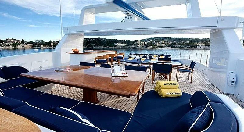 a large room with a table and chairs on it aboard OXYGEN Yacht for Sale