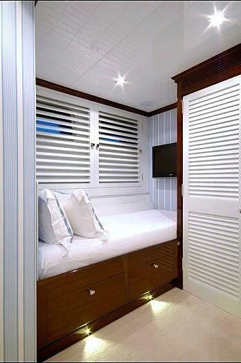 a bedroom with a bed and a television aboard OXYGEN Yacht for Sale