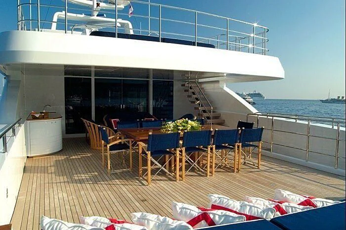 a patio with a table and chairs on it aboard OXYGEN Yacht for Sale