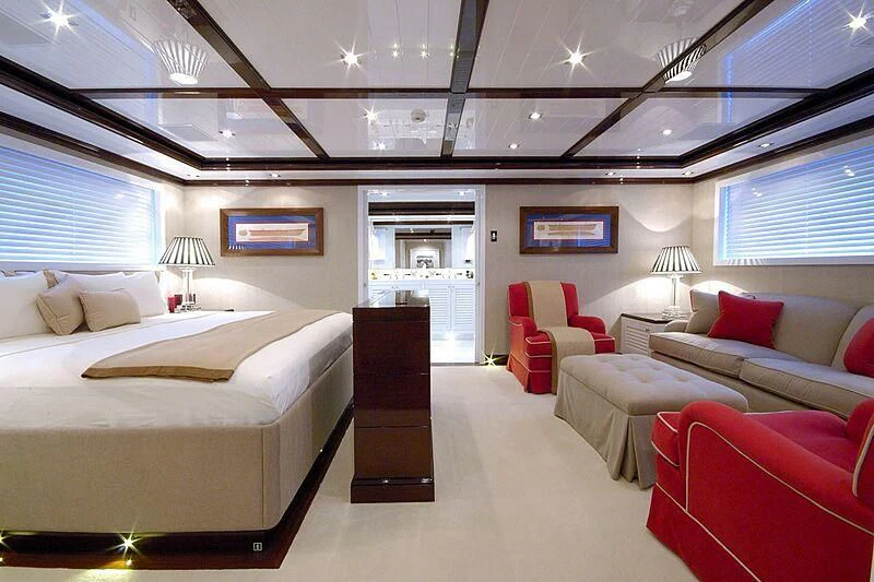 a room with a bed and a couch aboard OXYGEN Yacht for Sale