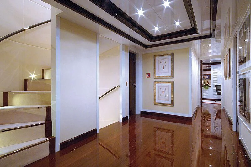 a room with a wood floor and white walls aboard OXYGEN Yacht for Sale