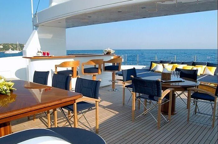a room with tables and chairs aboard OXYGEN Yacht for Sale