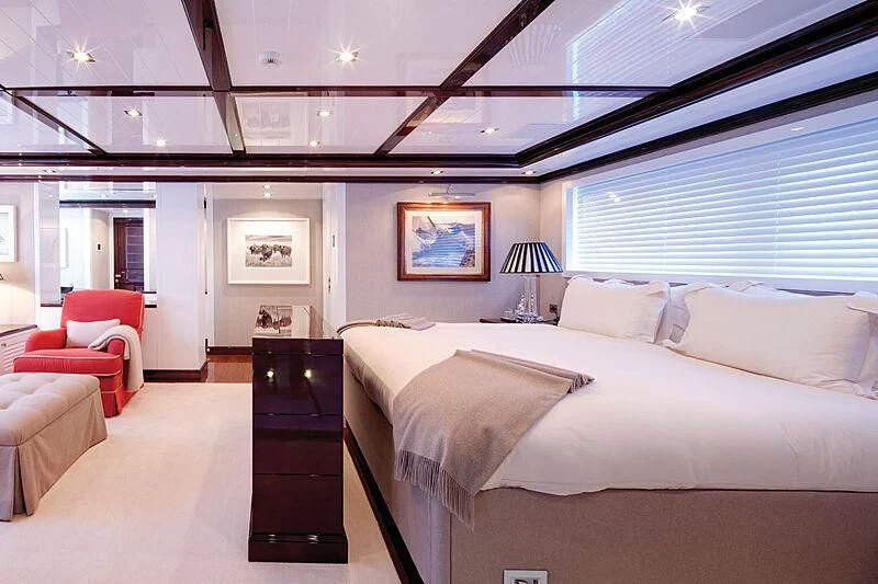 a room with a bed and a chair aboard OXYGEN Yacht for Sale