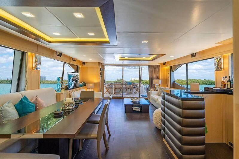 a room with a table and couches aboard FULL CIRCLE Yacht for Sale