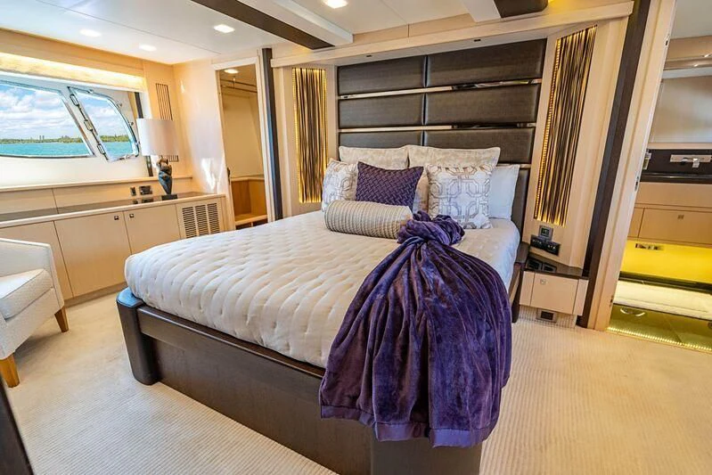 a bedroom with a bed and a desk aboard FULL CIRCLE Yacht for Sale