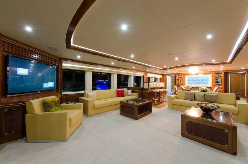 a living room with a large screen aboard OBSESSION Yacht for Sale