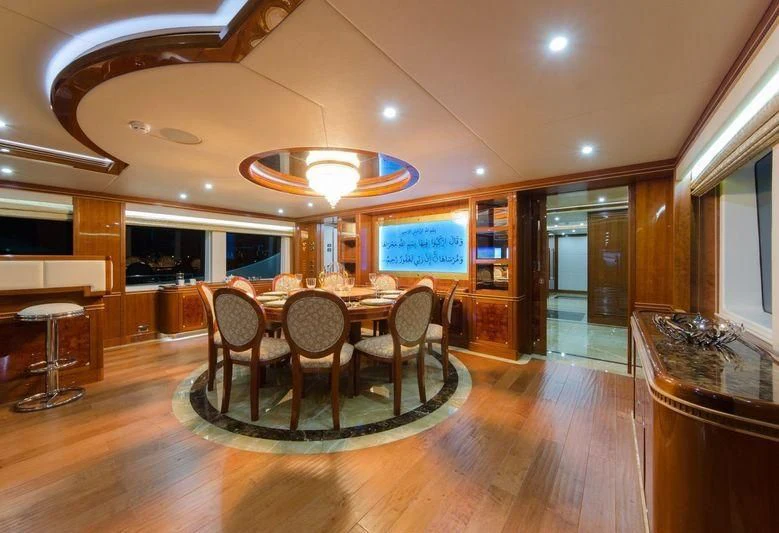 a dining room with a table and chairs aboard OBSESSION Yacht for Sale