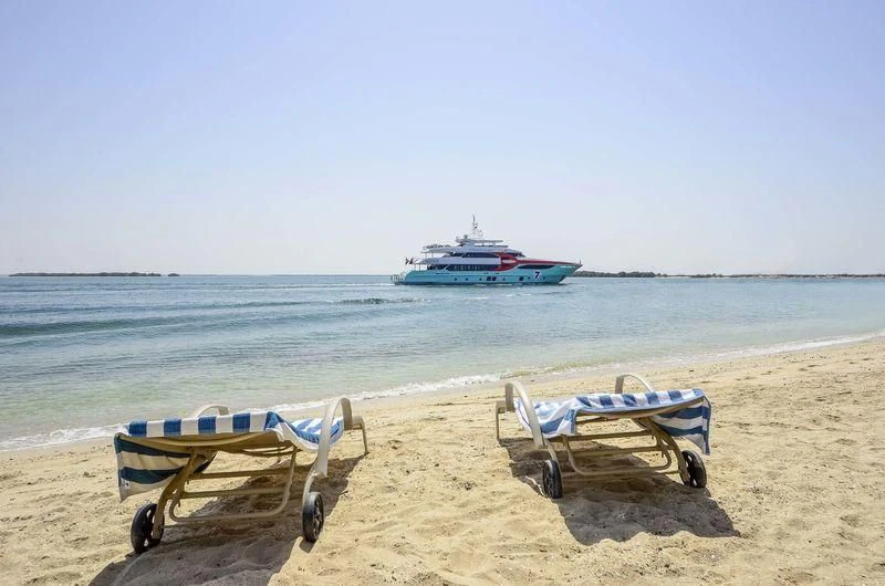 a couple of chairs on a beach aboard OBSESSION Yacht for Sale