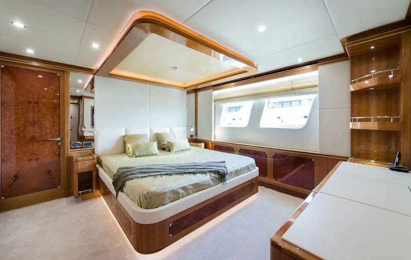 a large bedroom with a bed aboard OBSESSION Yacht for Sale