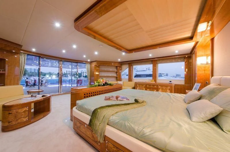 a large bedroom with a large window aboard OBSESSION Yacht for Sale