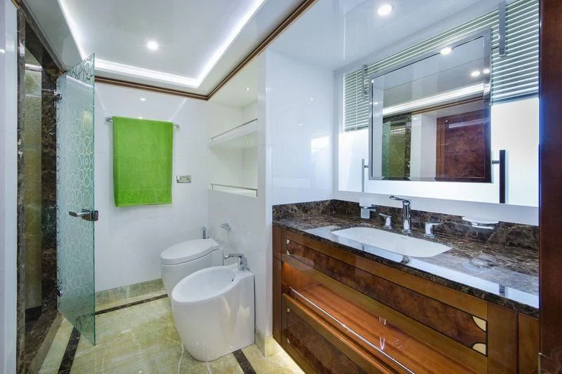 a bathroom with a sink and a toilet aboard OBSESSION Yacht for Sale