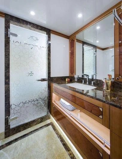 a bathroom with a large mirror aboard OBSESSION Yacht for Sale