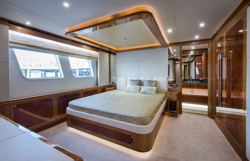 a room with a bed and a mirror aboard OBSESSION Yacht for Sale