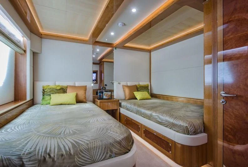 a couple of beds in a room aboard OBSESSION Yacht for Sale